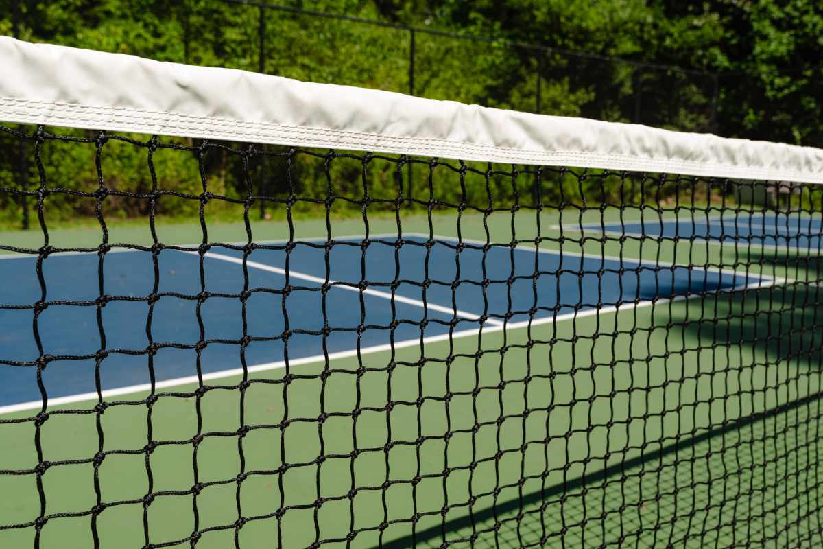 A close-up view of the net on a pickleball court. 