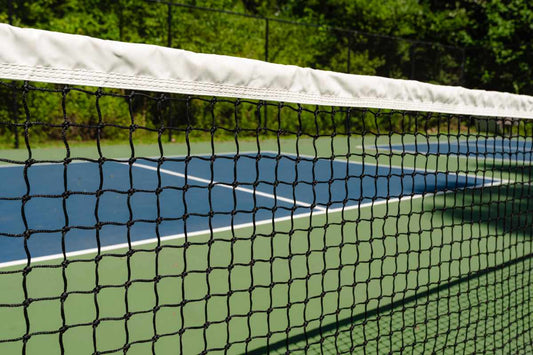A close-up view of the net on a pickleball court. 