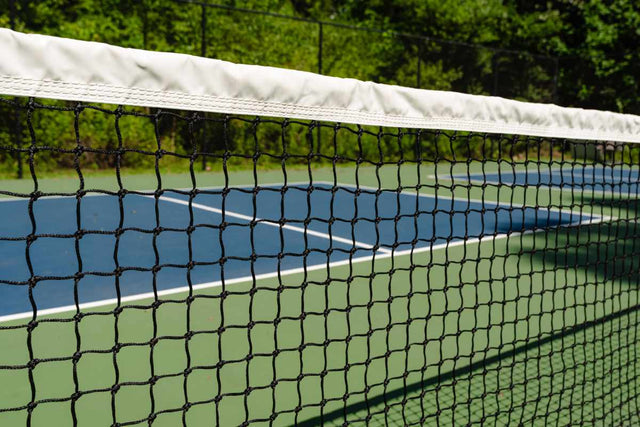 A close-up view of the net on a pickleball court. 