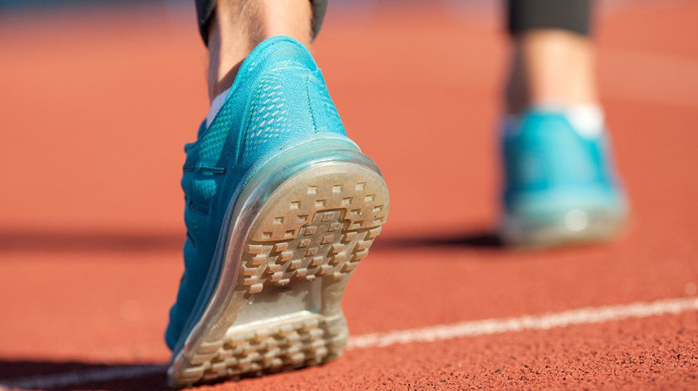 man wearing shoes and playing pickleball
