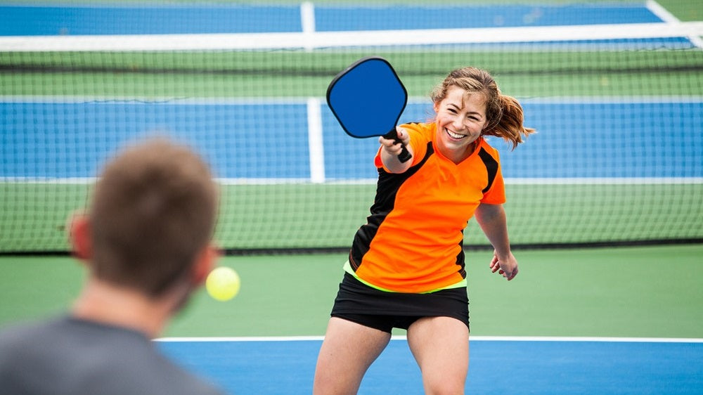 young couple playing pickleball