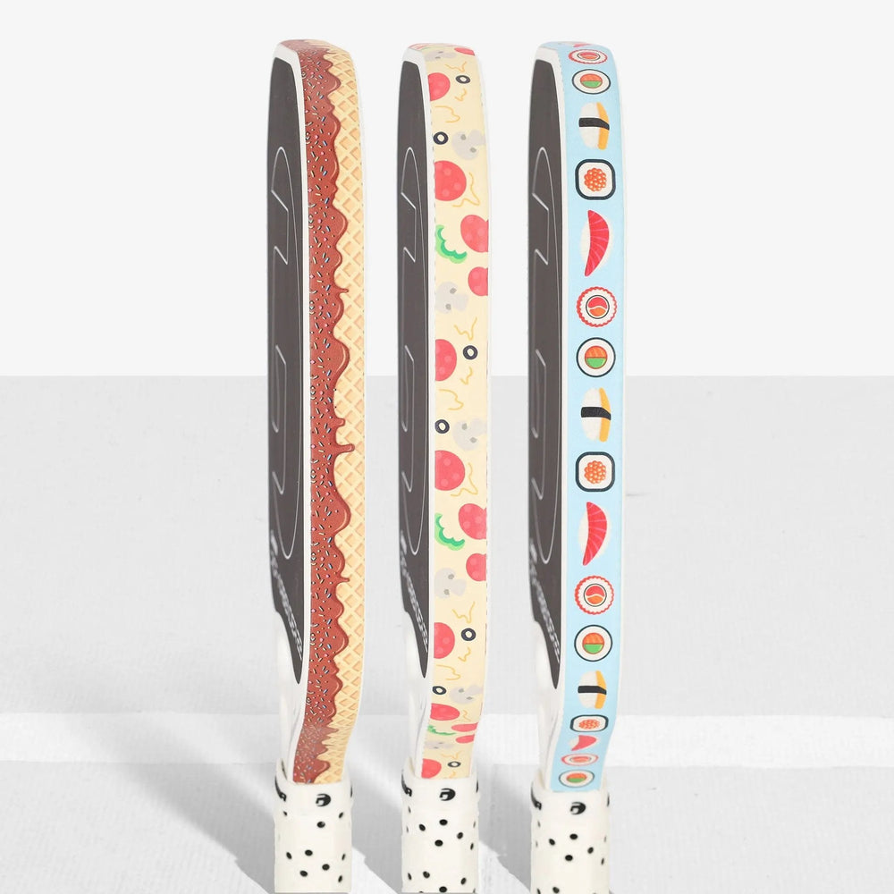Three pickleball paddles wrapped in GAMMA ice cream, pizza and sushi edge guard tape
